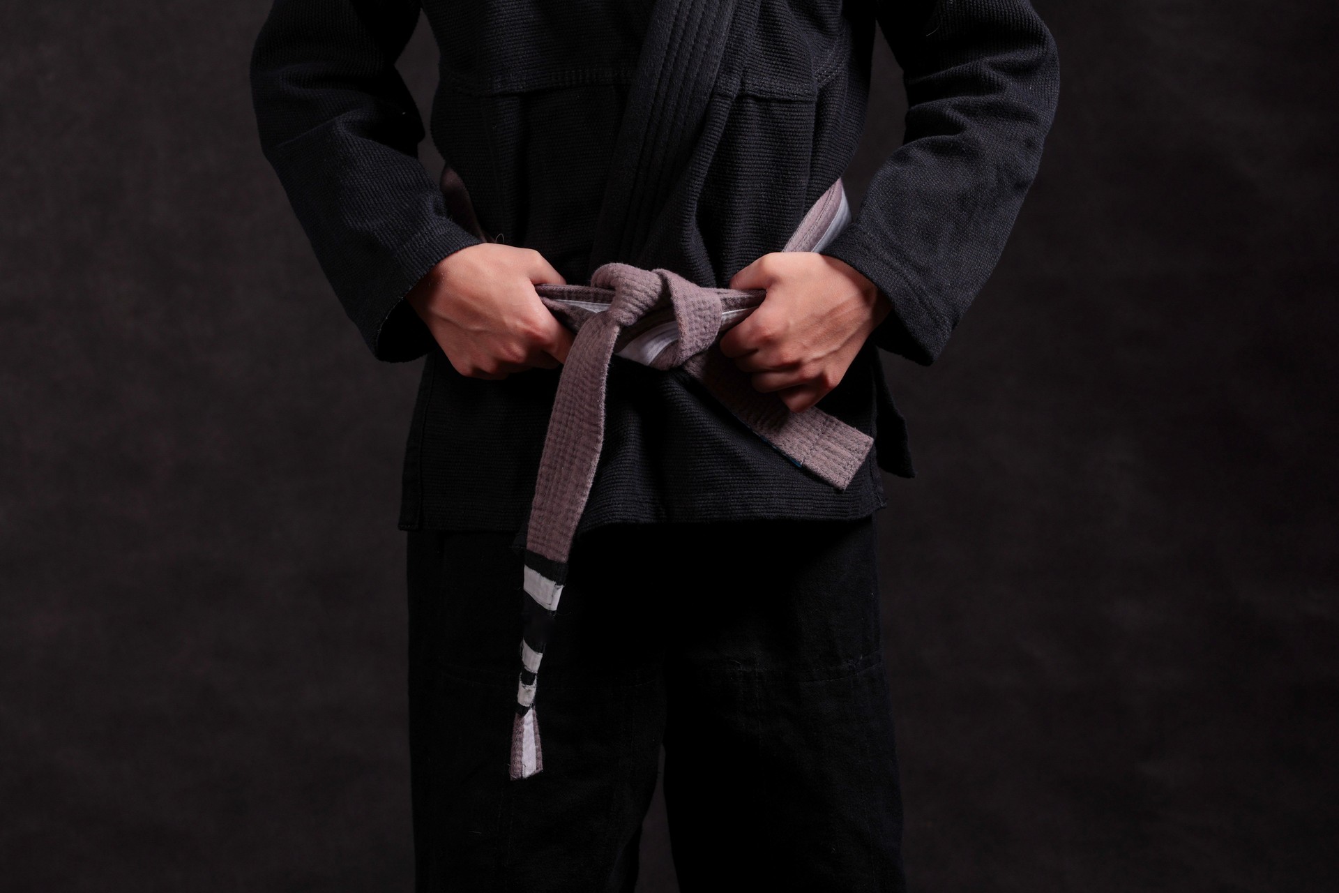black children's kimono for Brazilian jiu jitsu with tied gray belt with progression straps